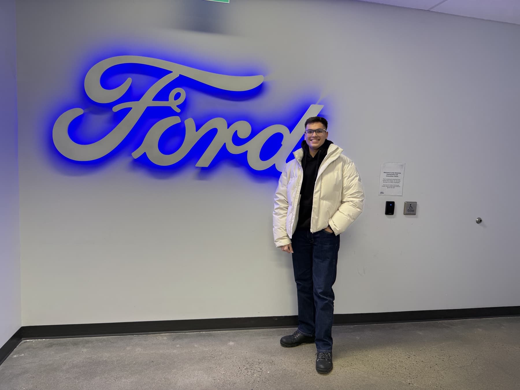 Manan standing beside the Ford wordmark